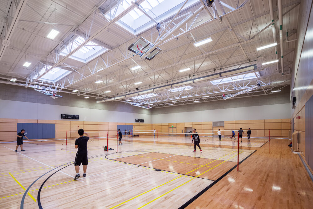 indoor court with kids playing badminton